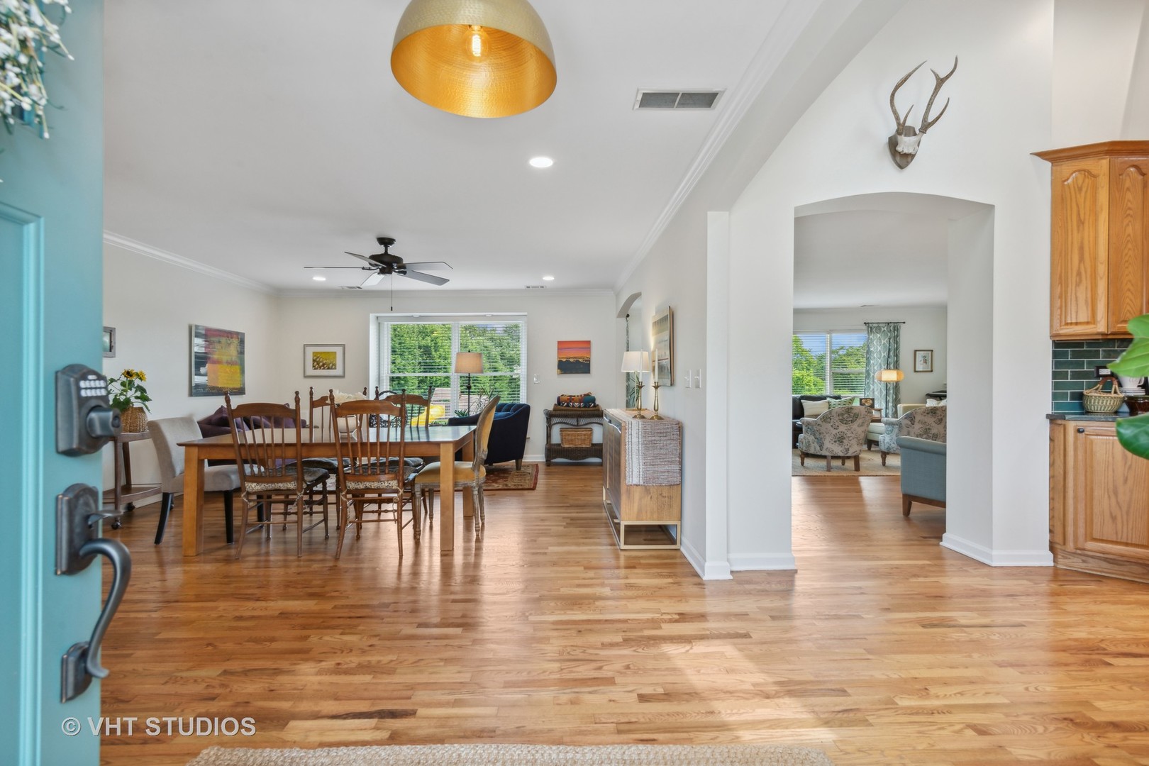 831 Ela Road Inverness, IL 60067 - Photo 8 of 46 a view of a dining room and livingroom with furniture wooden floor a chandelier