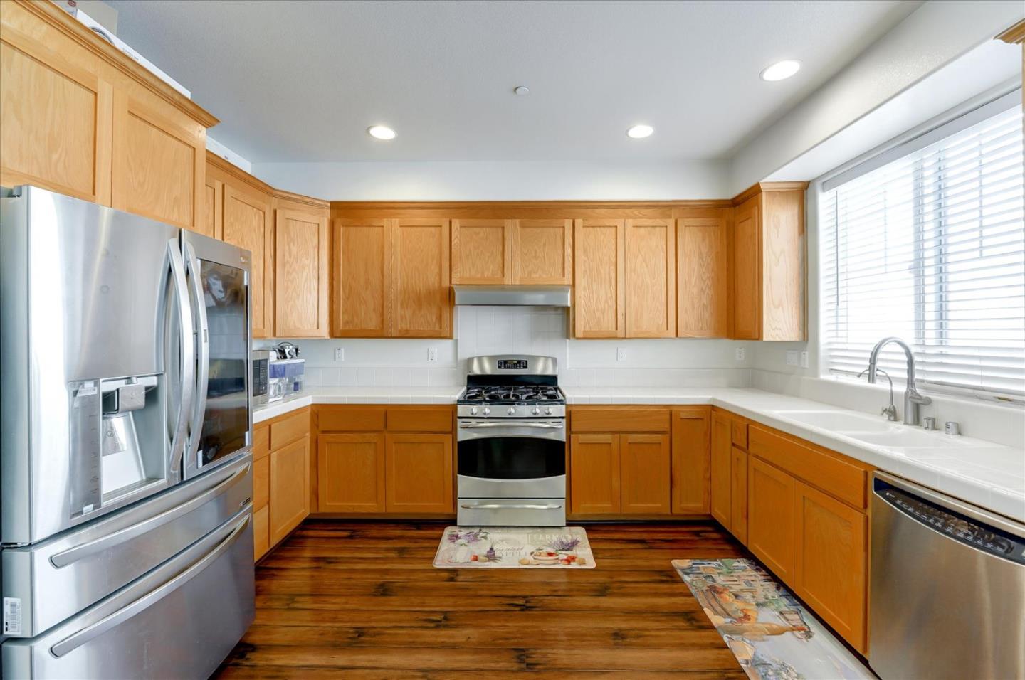 18413 Ruby Lane Morgan Hill, CA 95037 - Photo 14 of 33 a kitchen with stainless steel appliances granite countertop a stove a refrigerator and a sink
