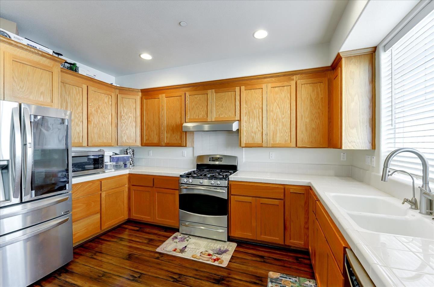 18413 Ruby Lane Morgan Hill, CA 95037 - Photo 15 of 33 a kitchen with stainless steel appliances granite countertop a sink a stove and refrigerator