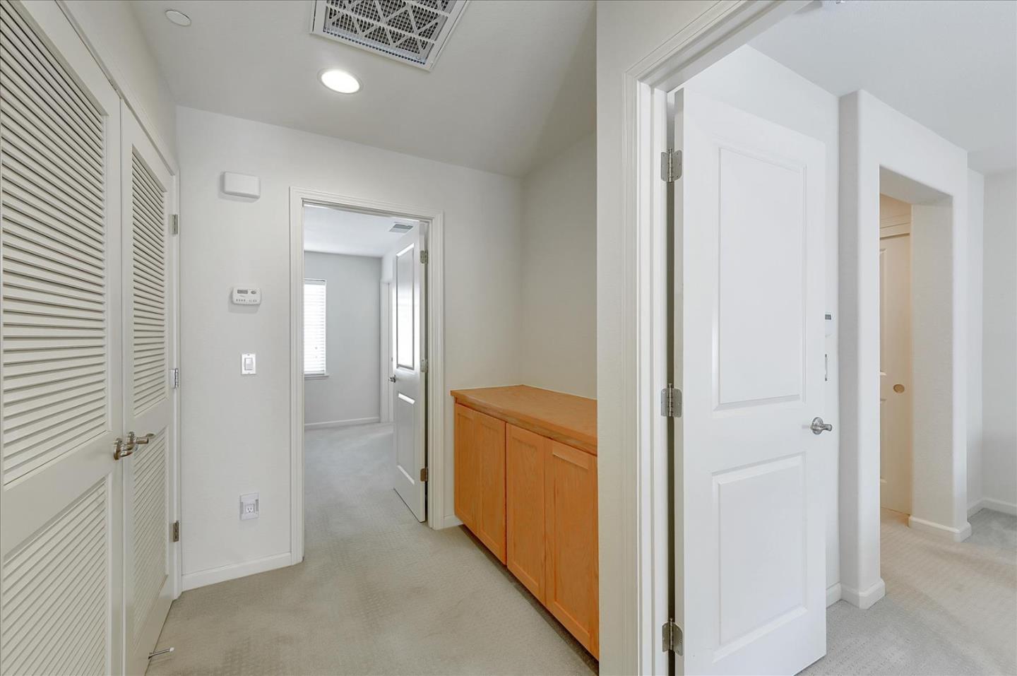18413 Ruby Lane Morgan Hill, CA 95037 - Photo 19 of 33 wooden view of a hallway with closet and mirror