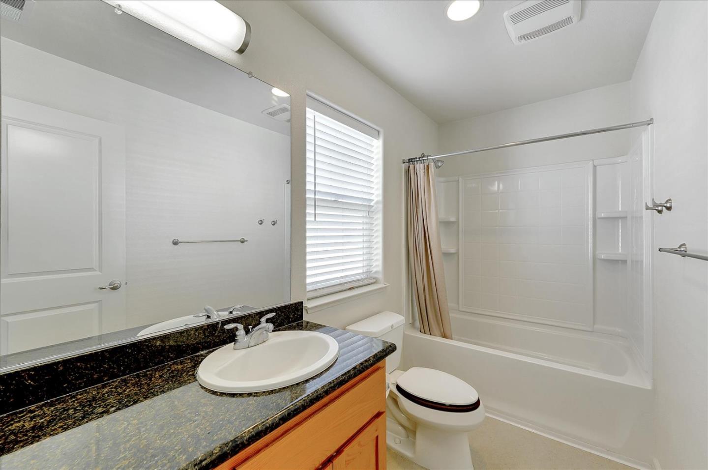18413 Ruby Lane Morgan Hill, CA 95037 - Photo 27 of 33 a bathroom with a granite countertop sink toilet and shower