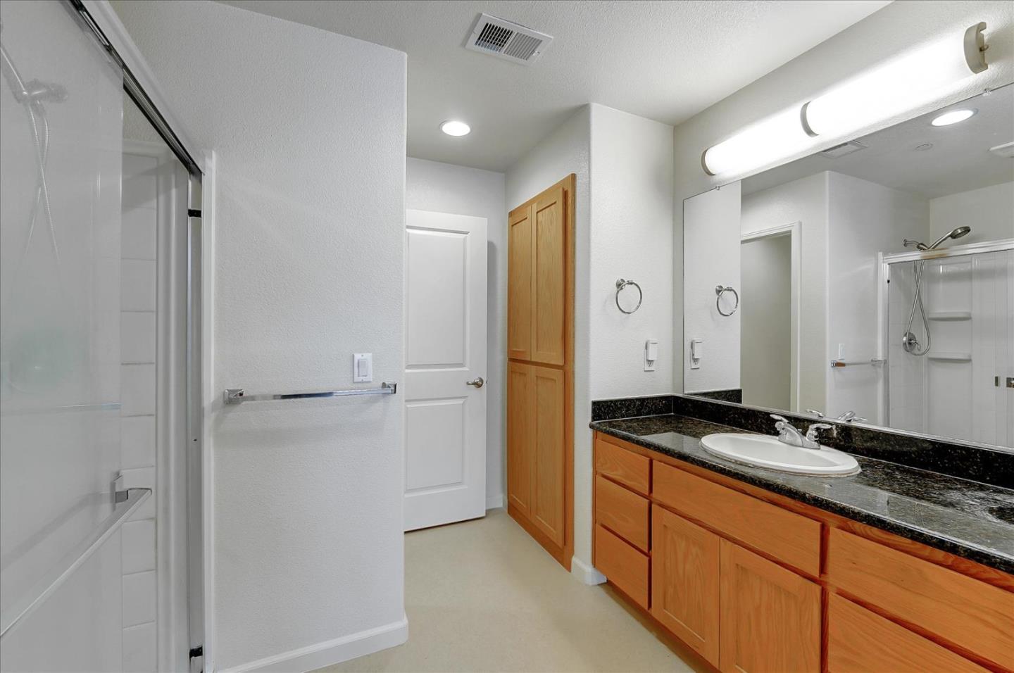 18413 Ruby Lane Morgan Hill, CA 95037 - Photo 29 of 33 a spacious bathroom with a granite countertop sink and a mirror