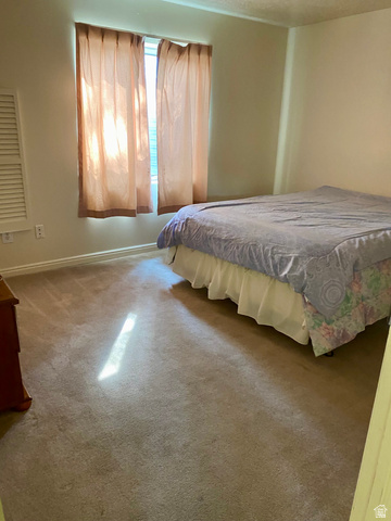 3918 Mapleleaf Way West Jordan, UT 84088 - Photo 8 of 12 Carpeted bedroom with baseboards