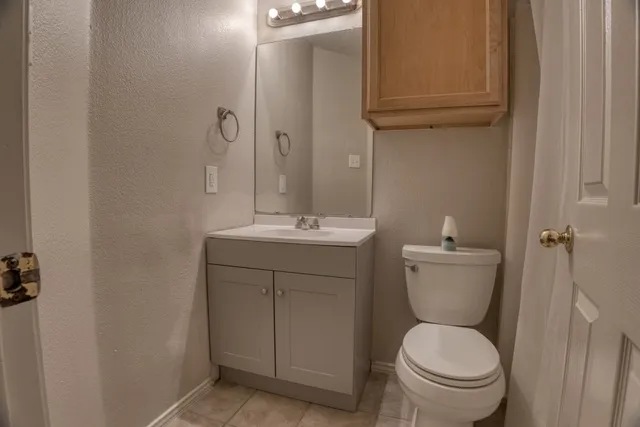 a view of a big room with wooden floor and windows