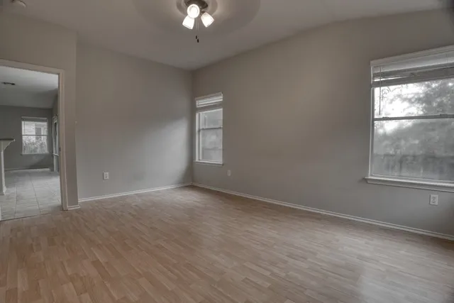wooden floor in an empty room with a window