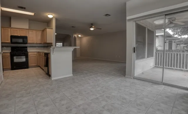 a view of kitchen with kitchen island and stainless steel appliances