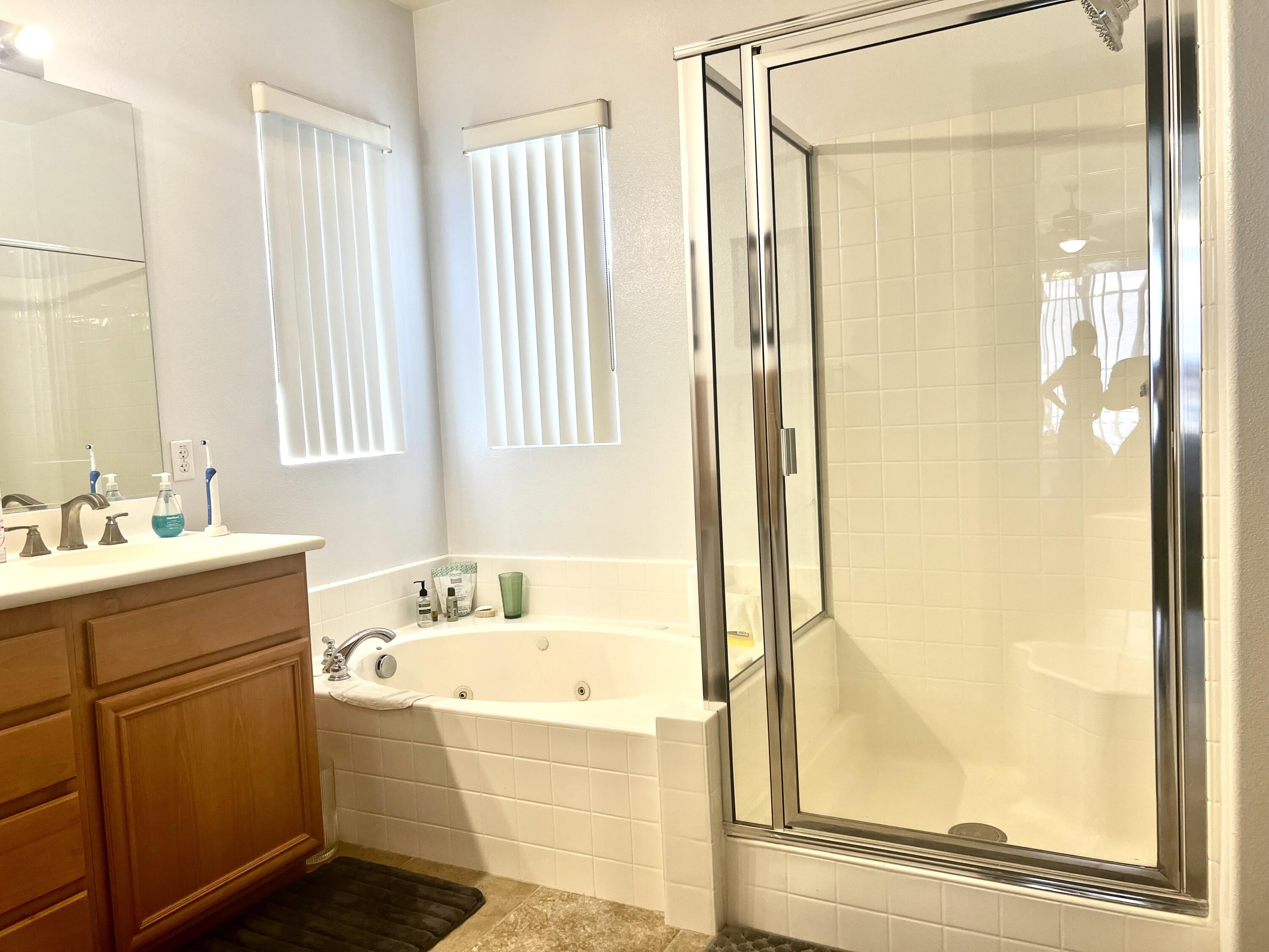 82782 Matthau Drive Indio, CA 92201 - Photo 12 of 27 a bathroom with a tub sink and mirror