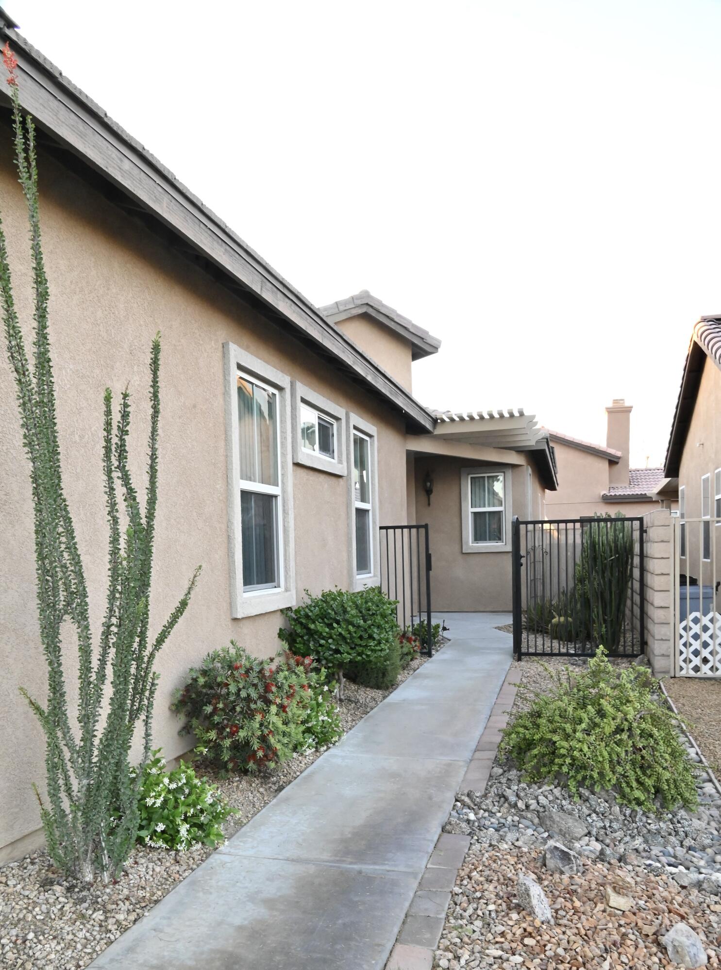 82782 Matthau Drive Indio, CA 92201 - Photo 21 of 27 a front view of a house with garden