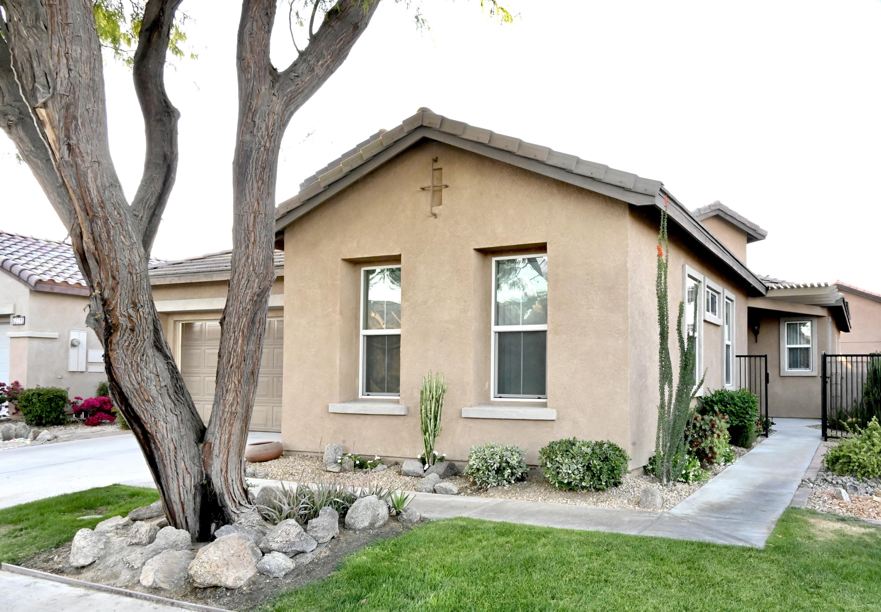 82782 Matthau Drive Indio, CA 92201 - Photo 5 of 27 a front view of a house with garden