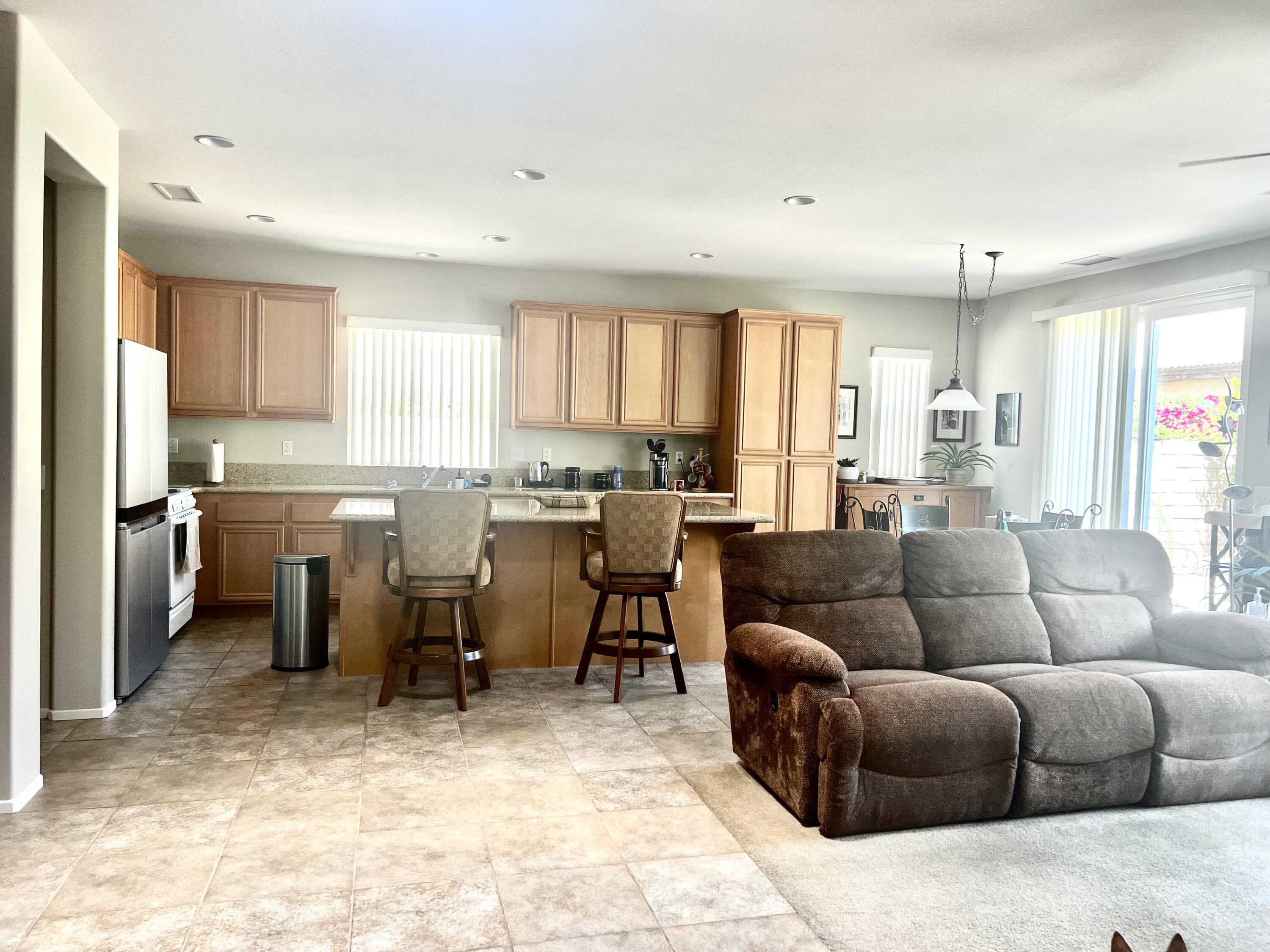 82782 Matthau Drive Indio, CA 92201 - Photo 9 of 27 a living room kitchen with furniture and windows