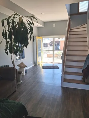 a view of entryway with stairs and wooden floor