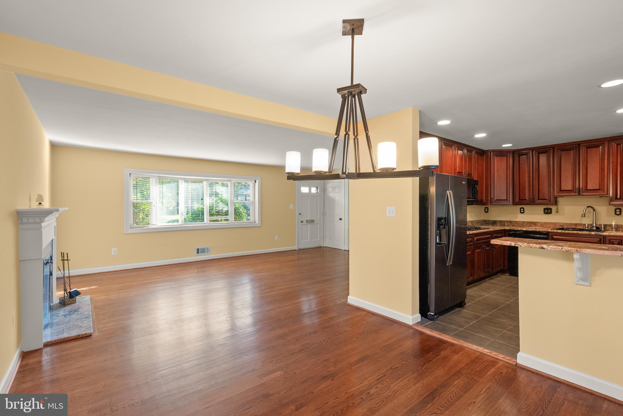 1726 Baldwin Drive McLean, VA 22101 - Photo 11 of 47 a view of a kitchen with a sink wooden floor a refrigerator and a window