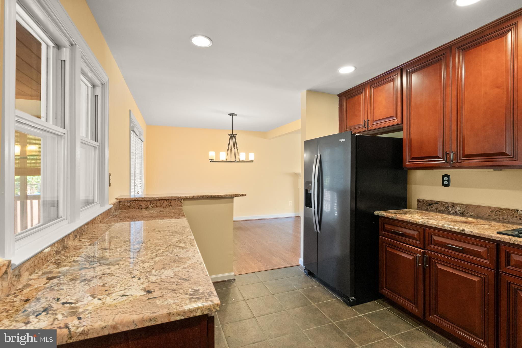 1726 Baldwin Drive McLean, VA 22101 - Photo 14 of 47 a kitchen with stainless steel appliances granite countertop a refrigerator and a stove top oven