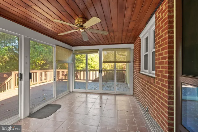 a view of a livingroom with a ceiling fan and window