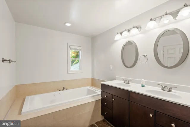 a bathroom with a double vanity sink and a mirror