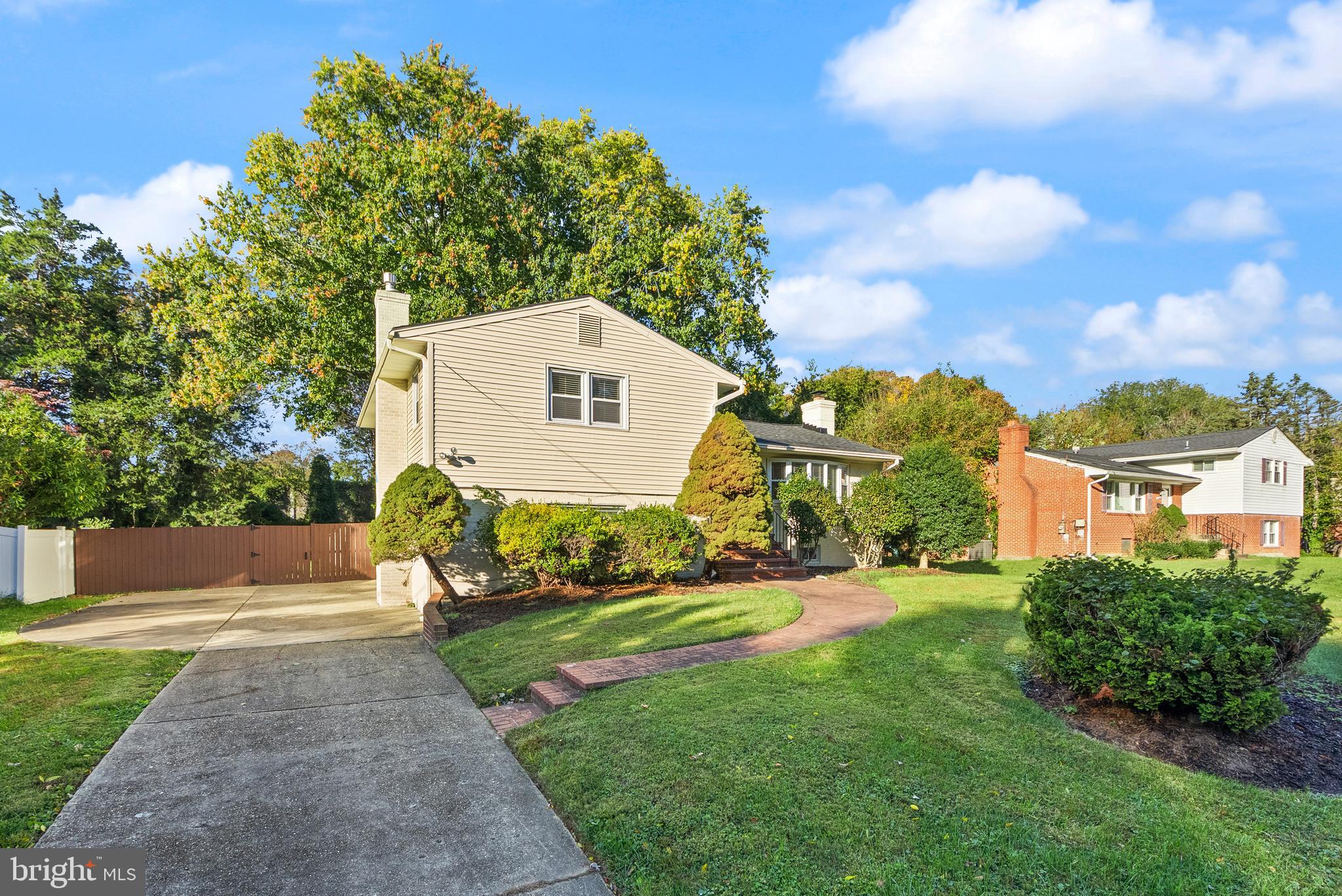 1726 Baldwin Drive McLean, VA 22101 - Photo 3 of 47 a front view of a house with a yard and trees