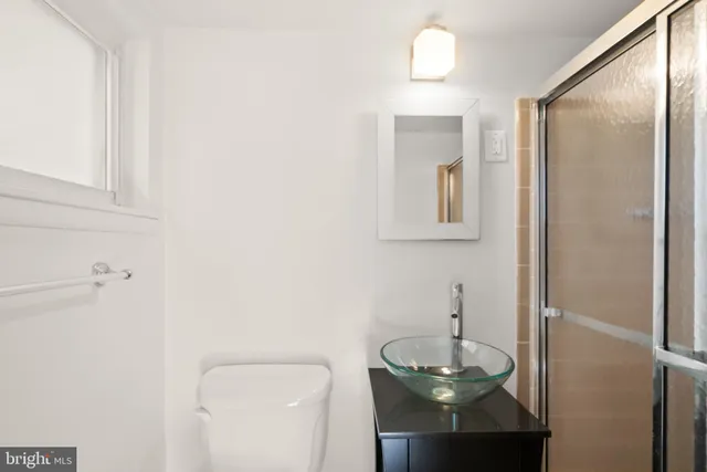 a bathroom with a toilet a sink and mirror