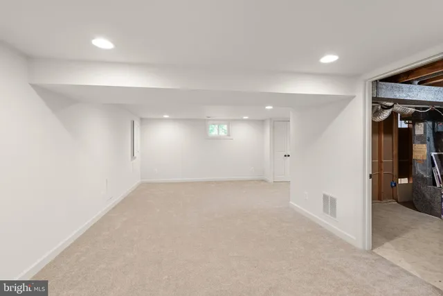 an empty room with a empty space and windows