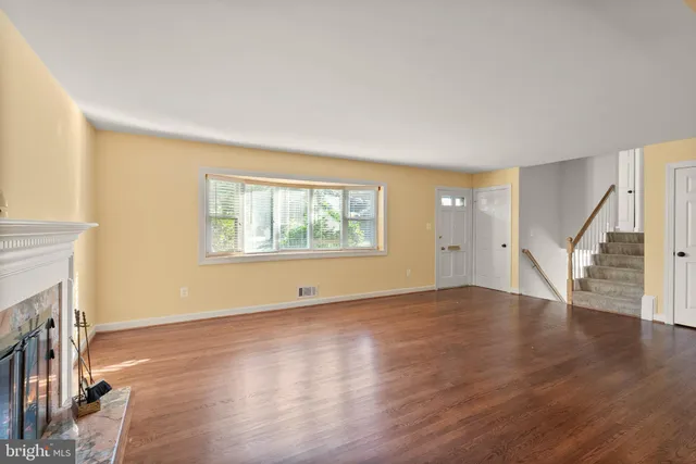 wooden floor in an empty room with a fireplace