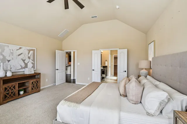 a bedroom with a bed and a chandelier