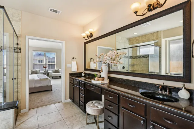 a spacious bathroom with a tub sink and mirror