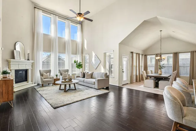 a living room with fireplace furniture and a large window