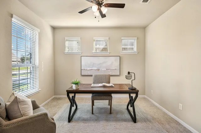 a workspace with furniture and window