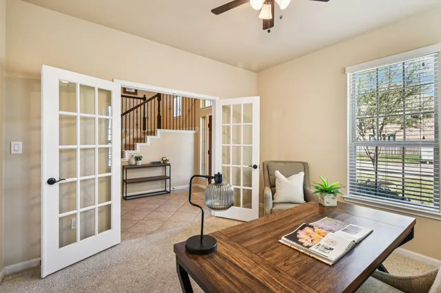 a living room with furniture and next to a window
