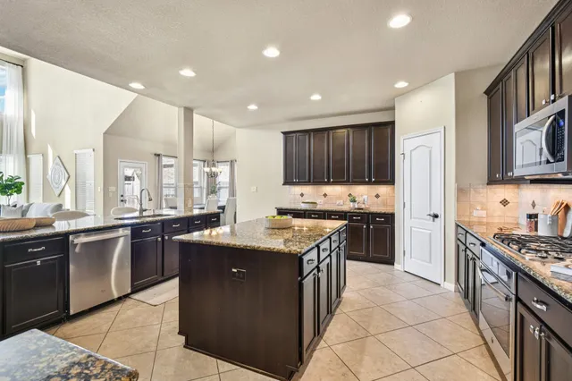a living room with furniture wooden floor and a large window