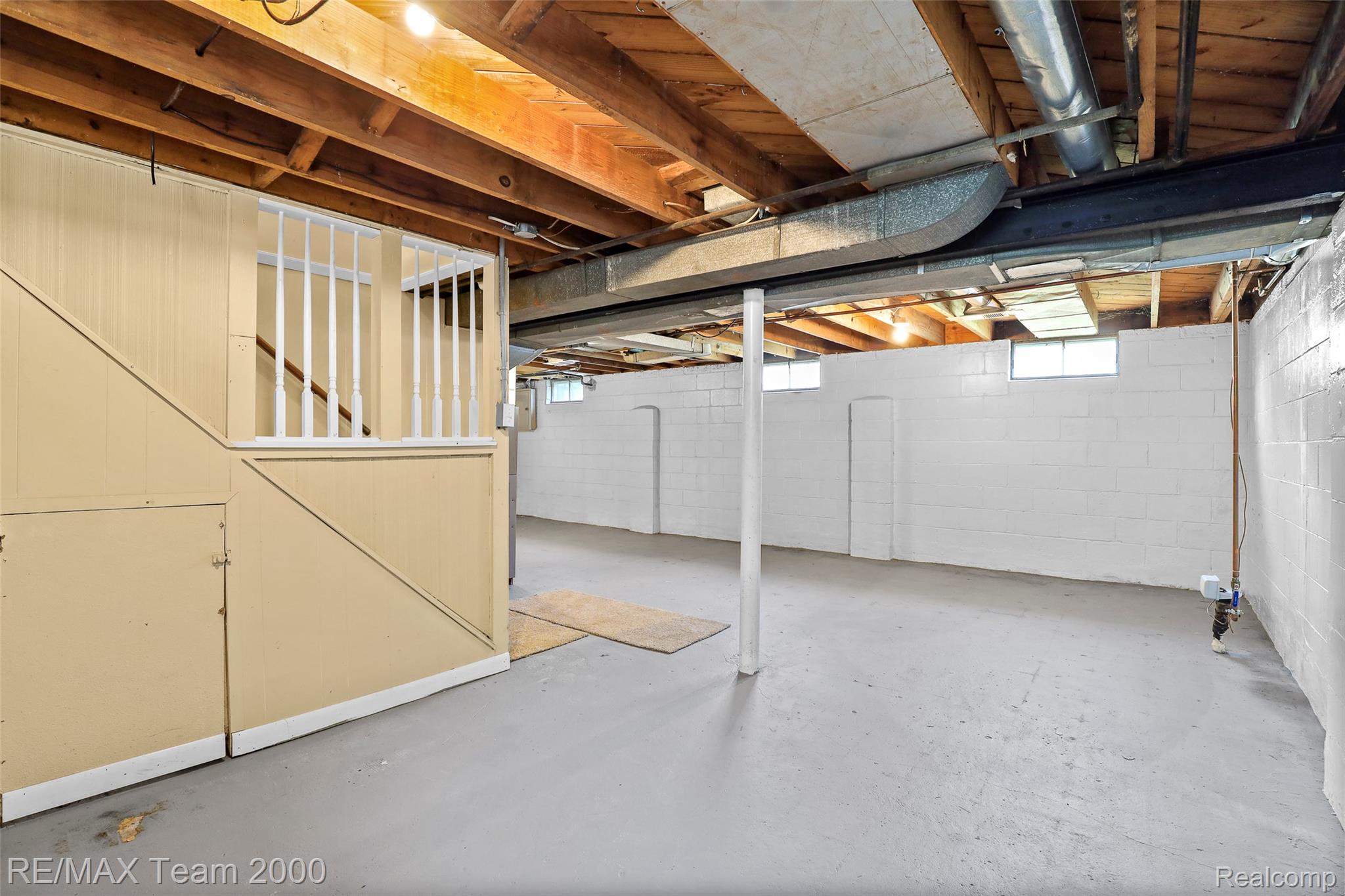 3130 Chestnut Street Dearborn, MI 48124 - Photo 23 of 30 Expansive basement space featuring exposed wood joists and concrete flooring