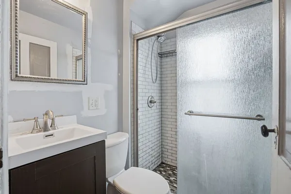 a bathroom with a sink toilet and shower
