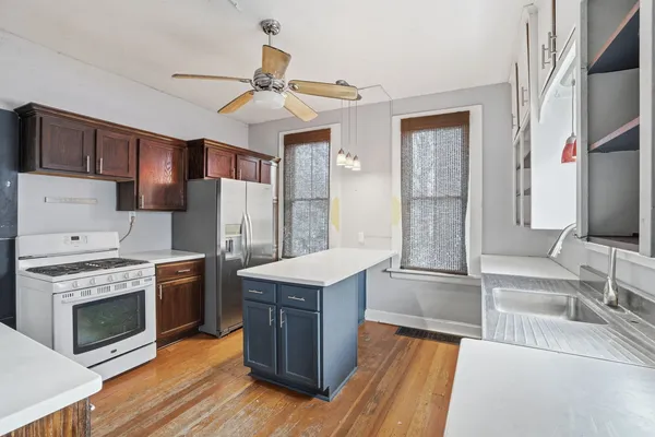 a kitchen with stainless steel appliances granite countertop a stove and a sink