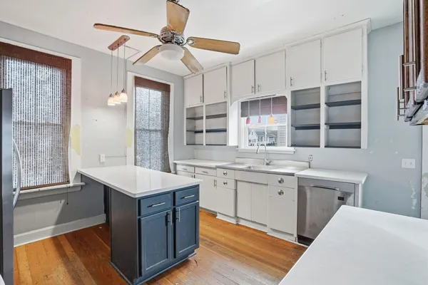 a kitchen with a sink stove and cabinets