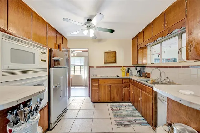 a large kitchen with stainless steel appliances granite countertop a sink and cabinets