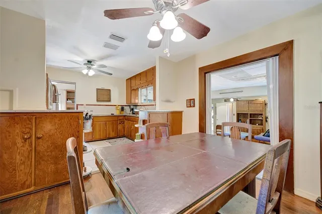 a view of a dining room with furniture and a chandelier