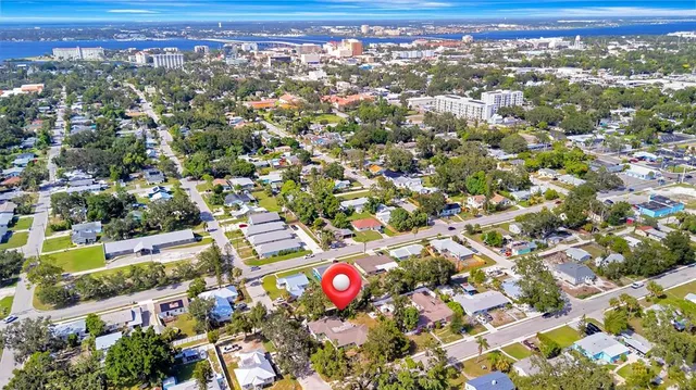 an aerial view of residential houses with outdoor space and parking
