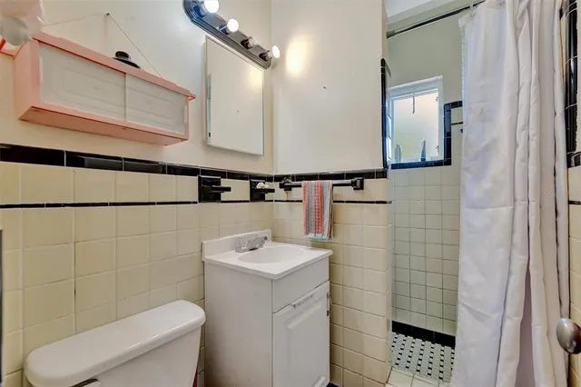 a bathroom with a sink a toilet and mirror