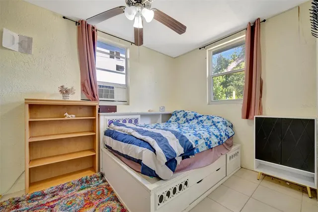 a bed room with a bed and a window