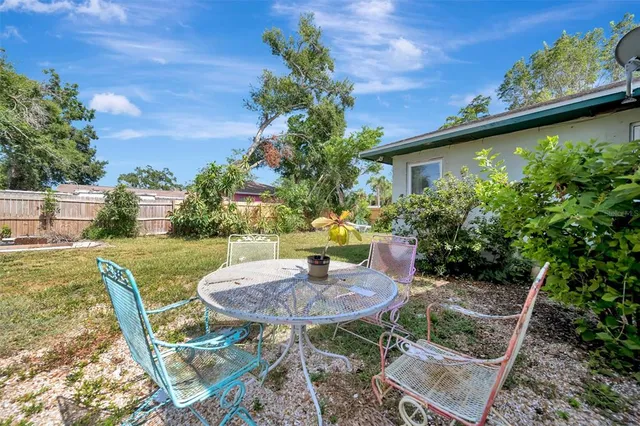 a view of a yard with plants and a trees