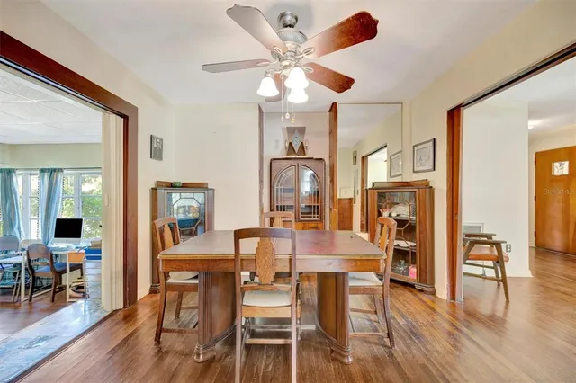 a view of a a dining room with furniture window and wooden floor