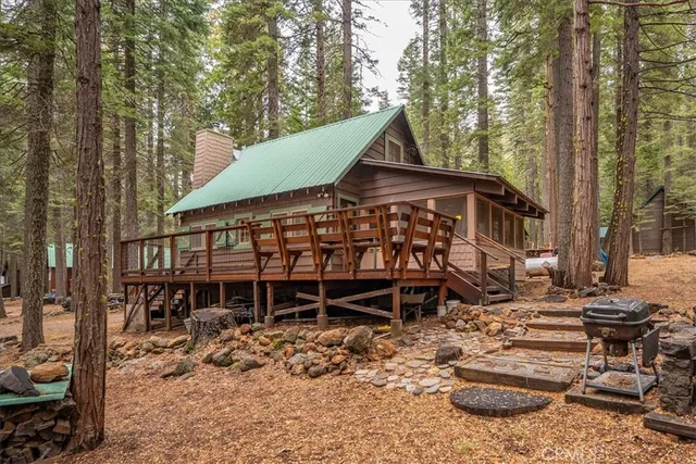 a view of a chairs and table in the backyard