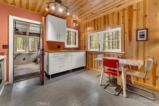 a view of a dining room with furniture and window