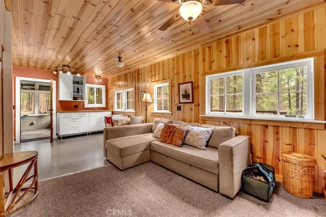 a living room with furniture and large window