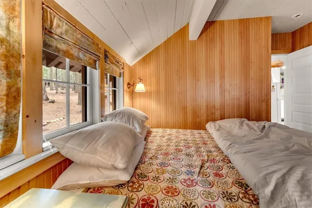 a bedroom with a large bed and a window