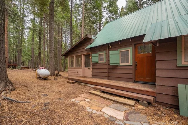 a view of a house with a yard and wooden fence