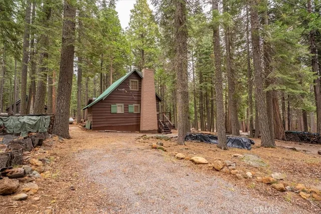 a view of a house with a yard covered in snow