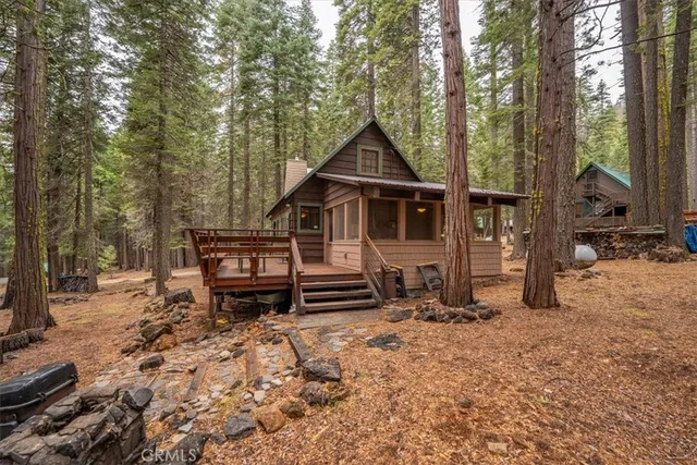 a view of a chairs and table in the backyard