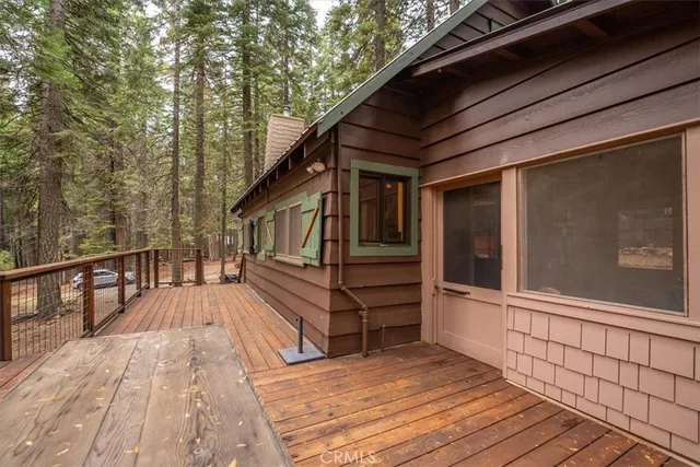 a view of a wooden deck with chairs and a table