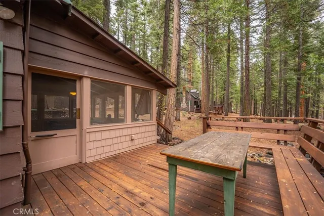 a dining room with furniture a chandelier and wooden floor