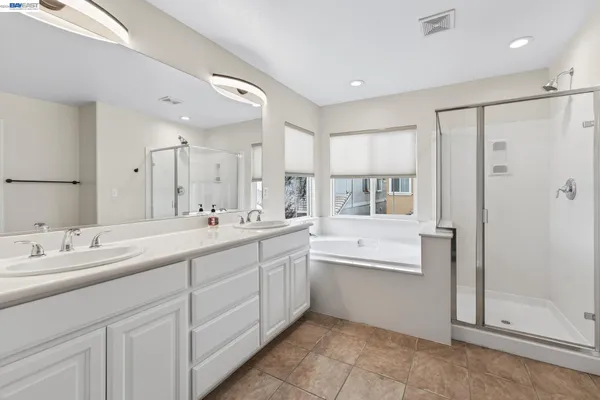 a front view of a house with a yard and potted plants